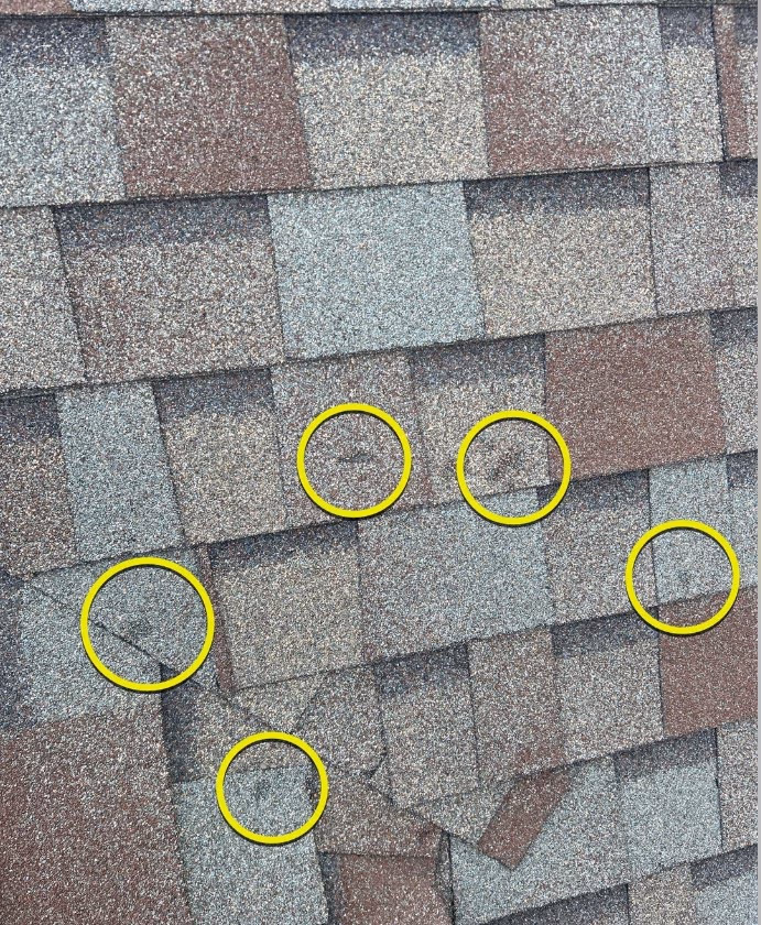 Roofer documenting hail damage for insurance claim Oklahoma City