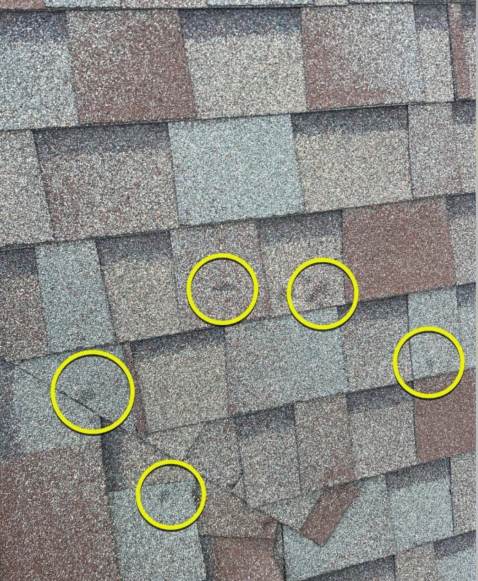 Roofer documenting hail damage for insurance claim Oklahoma City